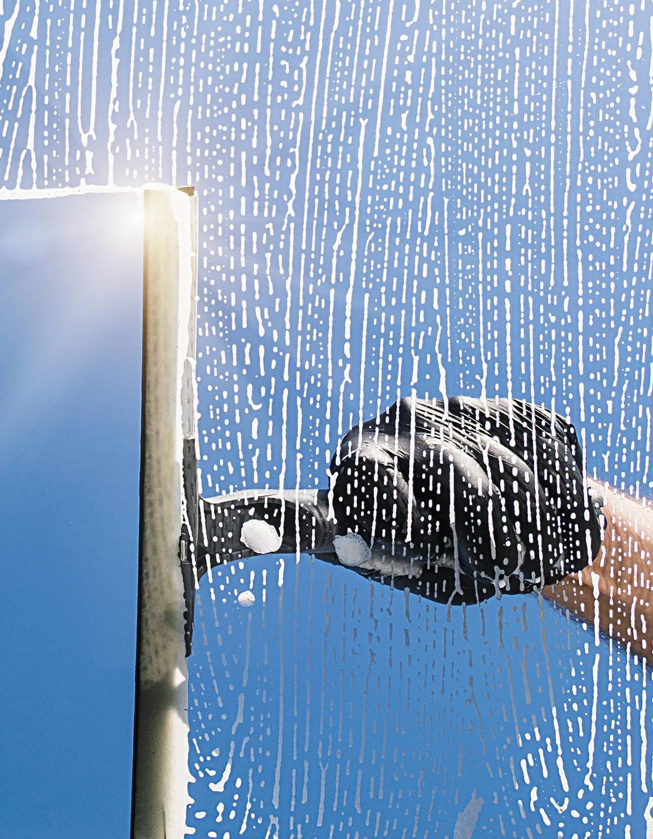 Detail work on window glass with a professional squeegee